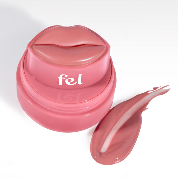 Fel Beauty's Kissylips Lip and Cheek Balm Product with custom lip-shaped applicator, next to a glossy smear of product. 